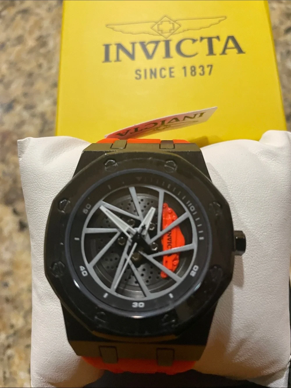Invicta Black Rim Watch with Orange Strap and Gray Dial Accents